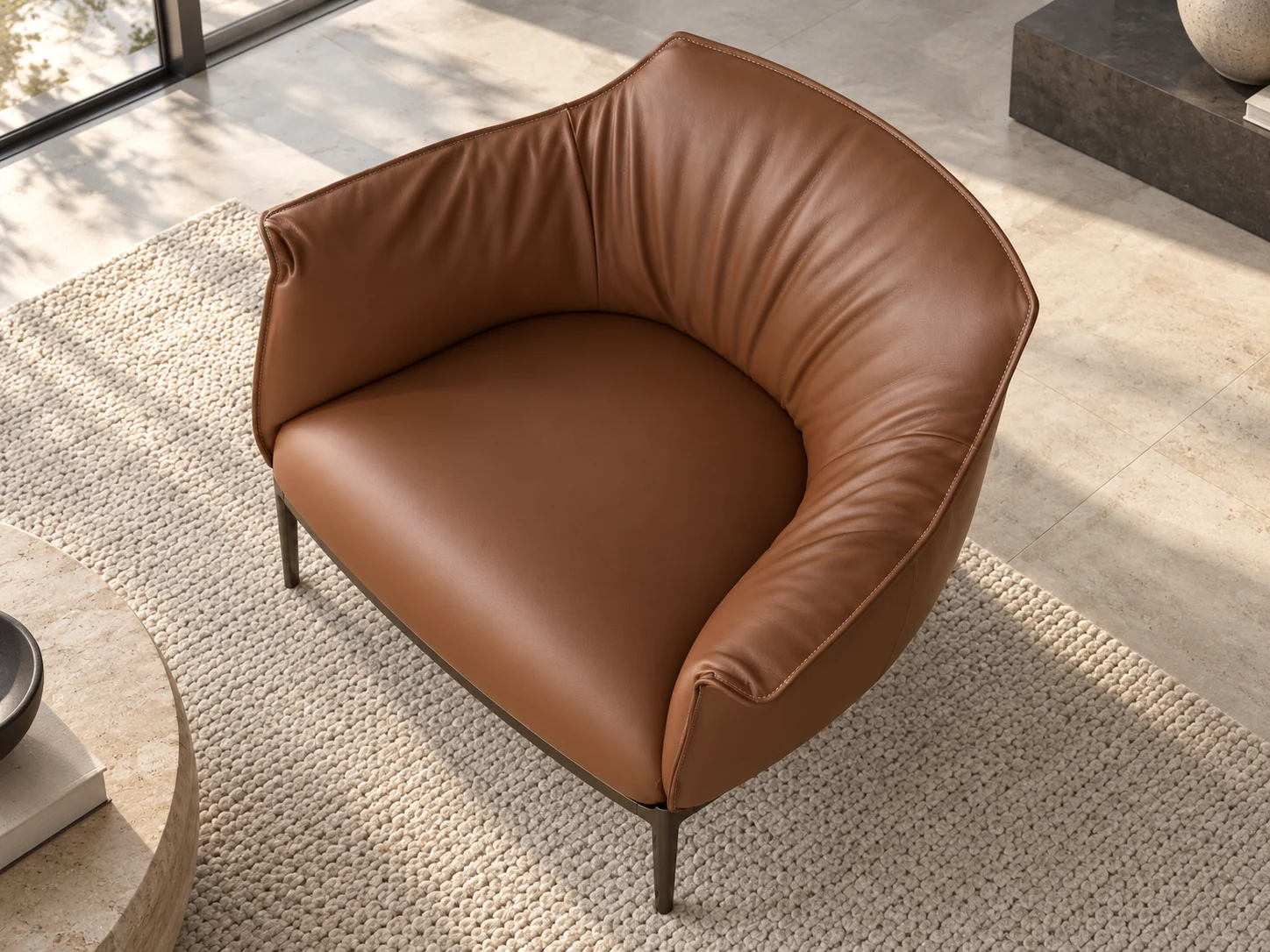 Archibald armchair seen from above, showing the curved back and slim metal base